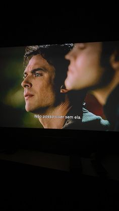 a tv screen showing the twilight saga breaking dawn with two young men looking at each other