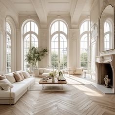 an elegant living room with large windows and wood flooring