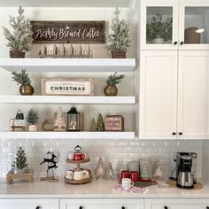 the shelves in this kitchen are decorated with christmas decorations and other holiday decorating items