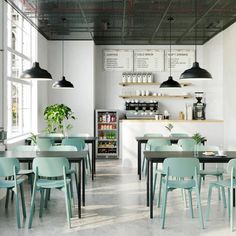 the interior of a restaurant with tables and chairs