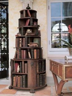 a tall wooden book shelf sitting next to a window