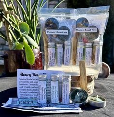 some jars and spoons are sitting on a table next to a money bowl kit