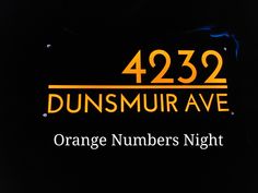 an orange numbers night sign with the words dunsmur avenue on it's side