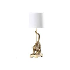 a lamp that has a cat on it with a white shade over the top and bottom