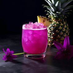 a pineapple and pink drink with ice