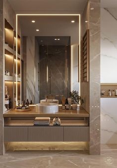 a modern bathroom with marble counter tops and gold accents