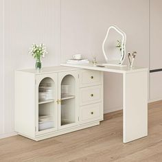 a white desk with two drawers and a mirror on the top shelf next to it