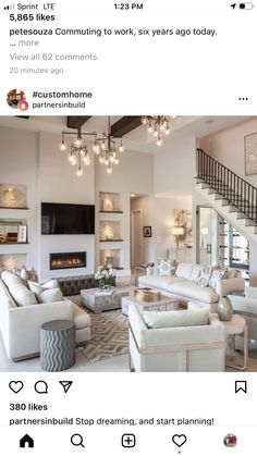 a living room with white furniture and chandelier hanging from the ceiling, on instagram