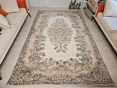 a living room with two couches and a rug on the floor