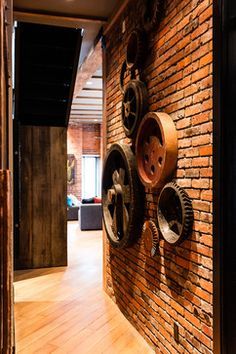 there is a brick wall with wheels on it in the hallway next to a door