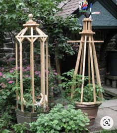 two wooden garden structures sitting next to each other