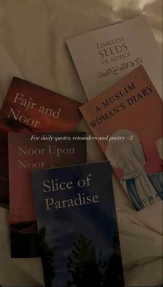 there are four books on the bed together, one is for children and one is for women's diarys