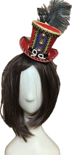 Classic Royal Nutcracker Top Hat Add elegant character to your Nutcracker shoots with the handmade Classic Royal Nutcracker Top Hat by The Head Mistress. A red satin top hat embellished with metallic jacquard trim, twisted satin rope, rhinestone buttons and embellishments and a velvet bow. A perfect addition to your nutcracker photo shoots! This lightweight top hat is fixed to a clip and fits all ages. Made in the USA Red Adjustable Hat For Costume Party, Adjustable Red Hat For Costume Party, Adjustable Red Mini Hat For Halloween, Red Costume Hat, Red Hats For Carnival Costume Party, Adjustable Red Hat For Carnival, Red Tall Crown Costume Hat For Party, Red Mini Hats For Halloween Costume Party, Adjustable Red Mini Hat For Costume Party