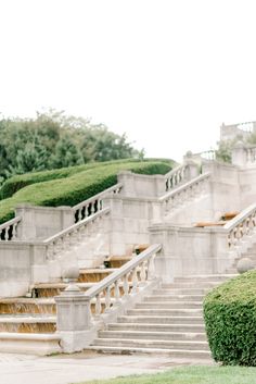 a woman is holding an umbrella while standing on the steps in front of some stairs