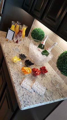 a kitchen counter topped with lots of fruit and veggies on top of it