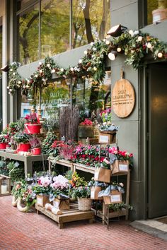 a flower shop with lots of flowers on display