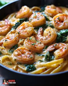 pasta with shrimp, spinach and cheese in a skillet on a wooden table