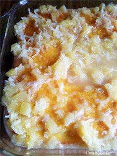 a casserole dish with potatoes and cheese in a glass pan on a table