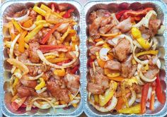 two plastic trays filled with meat and veggies on top of a table