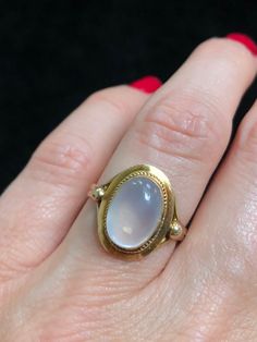 Retro era 14k gold and moonstone ring.  Moonstone is thought to promote emotional balance, and enhance calm, helping you to find inner peace and stability. Moonstone also encouraging and promotes joy while embarking on new beginnings. This ring is size 7.25 Luxury Antique Style Moonstone Ring, Luxury Vintage Oval Cabochon Moonstone Ring, Luxury Vintage Moonstone Ring As A Gift, Luxury Vintage Moonstone Ring For A Gift, Heirloom Yellow Gold Moonstone Cabochon Ring, Yellow Gold Oval Cabochon Moonstone Ring, Spiritual Yellow Gold Oval Opal Ring, Heirloom Yellow Gold Moonstone Ring, Oval Cabochon, Heirloom Yellow Gold Oval Cabochon Moonstone Ring