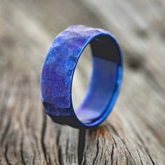 a blue ring sitting on top of a wooden table