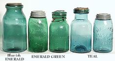 four different colored glass jars lined up next to each other with labels on them that read blue, emerald green, teal, and clear