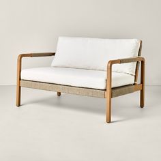 a white couch sitting on top of a wooden frame