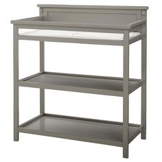 a baby changing table with three shelves