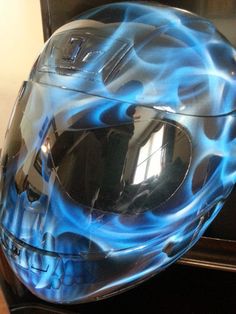 a motorcycle helmet with blue flames on it