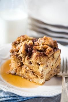 a piece of cake sitting on top of a white plate next to a glass of milk