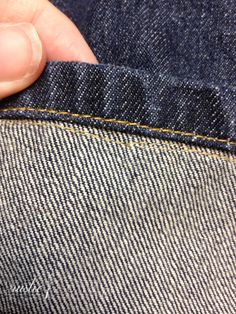 a person is holding their pocket open to show the inside of his jeane pants