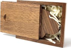 an open wooden box with shredded white paper in it's opening and the lid opened