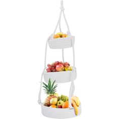 three tiered fruit basket with pineapple, oranges and bananas