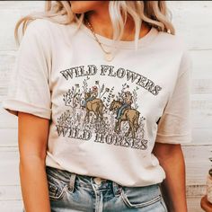 Wild Flowers Wild Horses Natural Shirt, Western Cowgirl Shirt, Trendy Western Shirt, Country Concert Shirt, Rodeo Graphic Shirt, Cute Cowgirl  Our T-shirts are made from premium materials and printed using advanced technology to ensure exceptional quality and comfort. Features: Premium brand: Gildan Soft Style Professionally printed using advanced technology Unisex size for a comfortable fit Made from soft, breathable cotton for all-day comfort Durable construction to withstand repeated wear and tear Easy Ordering: 1.Browse our design options. 2.Choose your size and color. 3.Choose the quantity you want. 4.Click "Add to Cart" to complete your purchase. Order Fulfillment: 💍Production time: 1-2 business days 💍Shipping time: 3-5 working days after production Return Policy: 💍Returns and exc Wrangler Shirts Womens, Western Shirts For Women, Country Graphic Tees, Country Concert Shirts, Cute Cowgirl, Western Stuff, Flowers Wild, Cowgirl Aesthetic, Wrangler Shirts