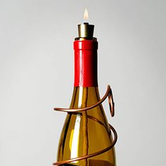 a wine bottle with a candle in it