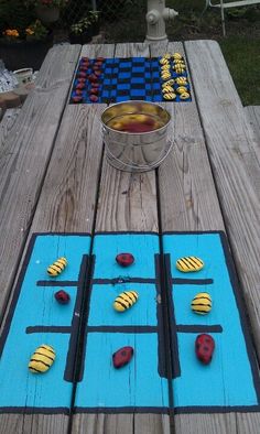 an outdoor game made out of wood and painted with blue, yellow and red paint