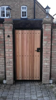 a large wooden door in front of a brick building