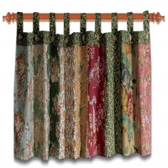 multicolored curtains hanging on a wooden rod