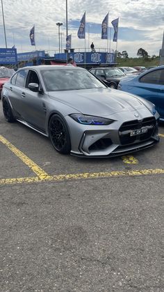 a grey sports car parked in a parking lot