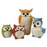 three ceramic owl figurines sitting next to each other