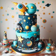 a space themed birthday cake with cupcakes and decorations