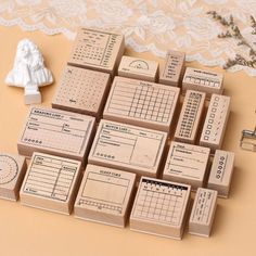 several wooden stamps with numbers and times on them sitting next to a lace doily