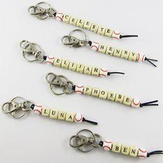 four personalized keychains with the name elizabeth written in white and red on them