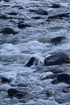 the water is rushing over some rocks in the river