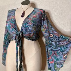 Brand New, Without Tags, Silk Like Fabric, Beautiful Paisley Print. Very Boho Vibes, Free Spirit Gypsy Shirt, Semi Crop Fit, Wrap Around Top. Can Also Be Worn Tied At The Front For A More Revealing Style. Features Long Sleeves With Bell Sleeves Detail. Measurements Laying Flat: Shoulder To Bottom 18”, Waist 15” (Approximate Measurements). Size Listed States L, However It Is A One Size, And There Is No Tag, Please See Measurements Listed Above Instead. Sewing Bell Sleeve Top, Bell Sleeve Top 70s, Boho Wrap Top, Boho Whimsical, Wrap Around Top, Bell Sleeve Shirt, Shirt Sewing Pattern, Lace Wrap, Fairy Grunge