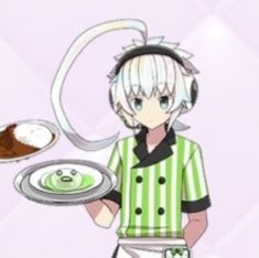 a man holding a plate with food on it and headphones in his ears,