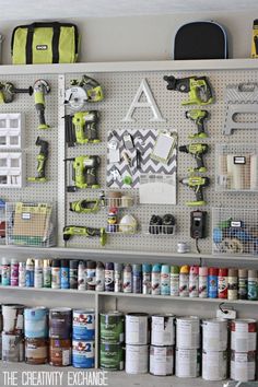 the pegboard is organized with paint and tools