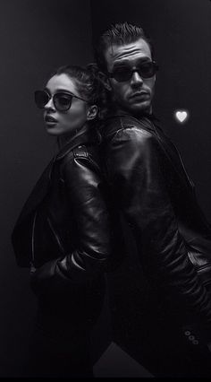 black and white photograph of man and woman in leather jackets with heart - shaped sunglasses