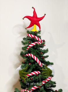 a christmas tree decorated with candy canes and an ornament in the shape of a star