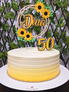 a cake with sunflowers and the number 50 on it is sitting on a table